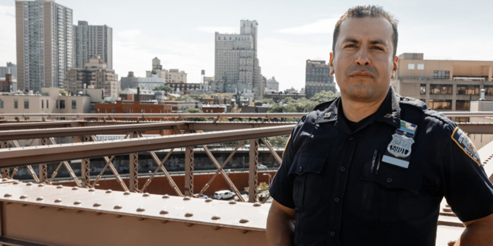 police officer leaning on bridge